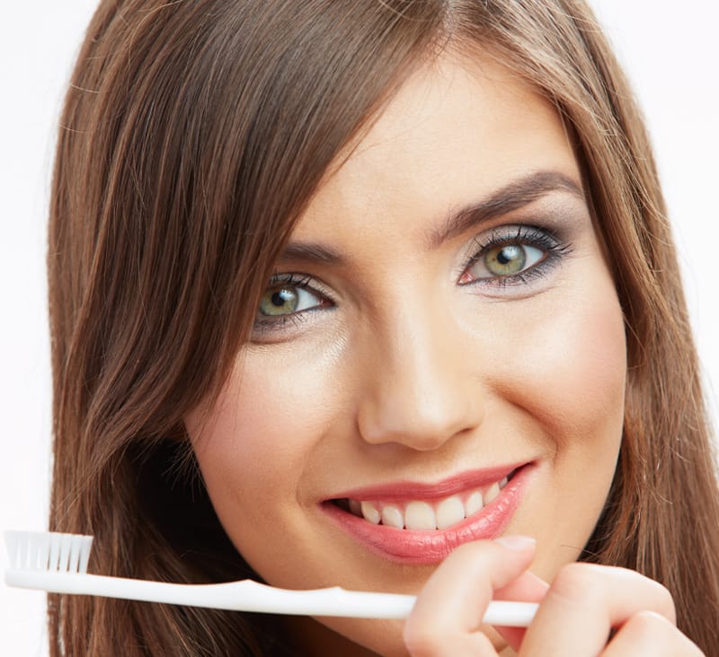 smiling woman with toothbrush